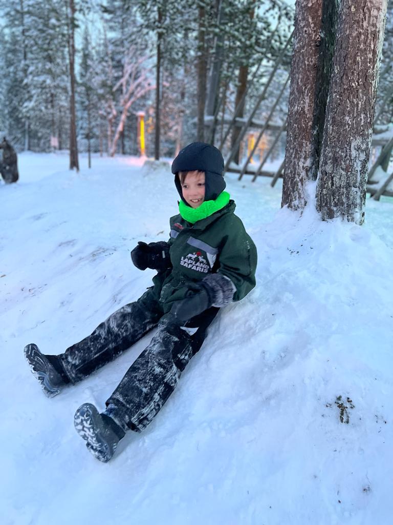 little boy sitting in snow