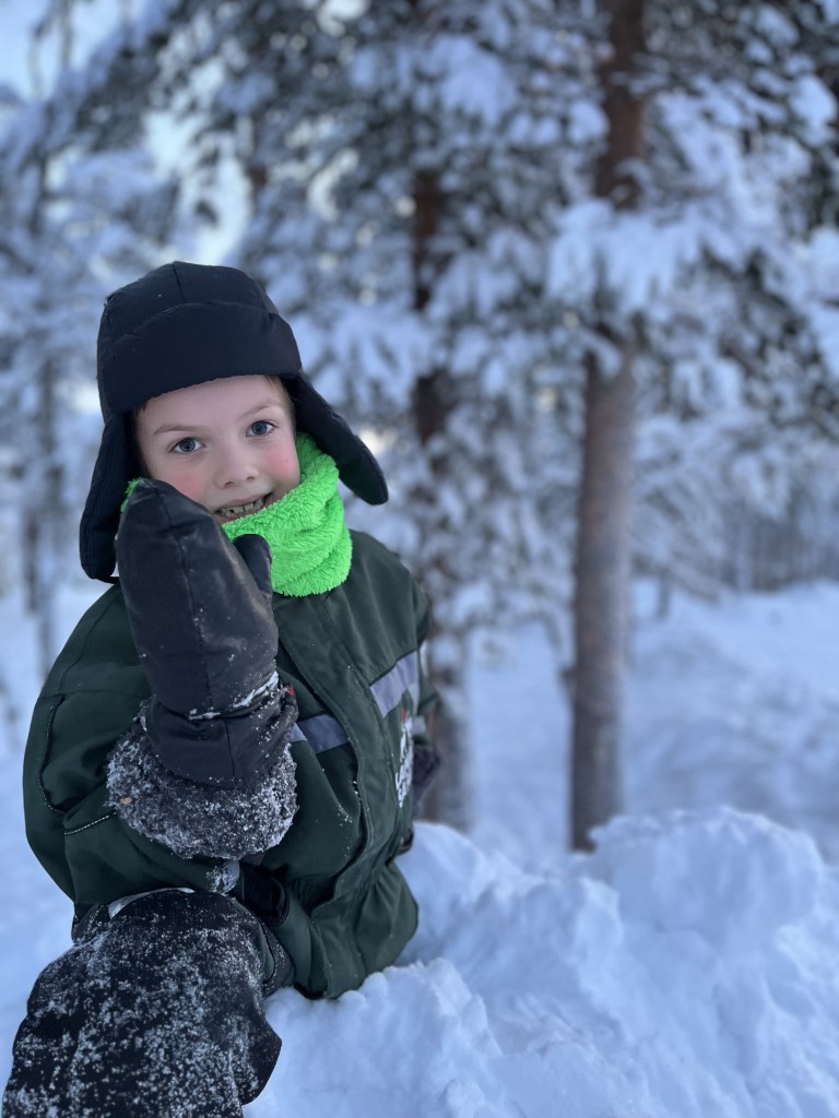 boy playing in snow at Saariselka