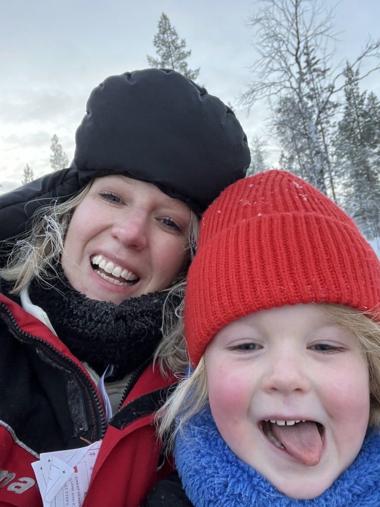 mum and daughter smiling together with warm hats on